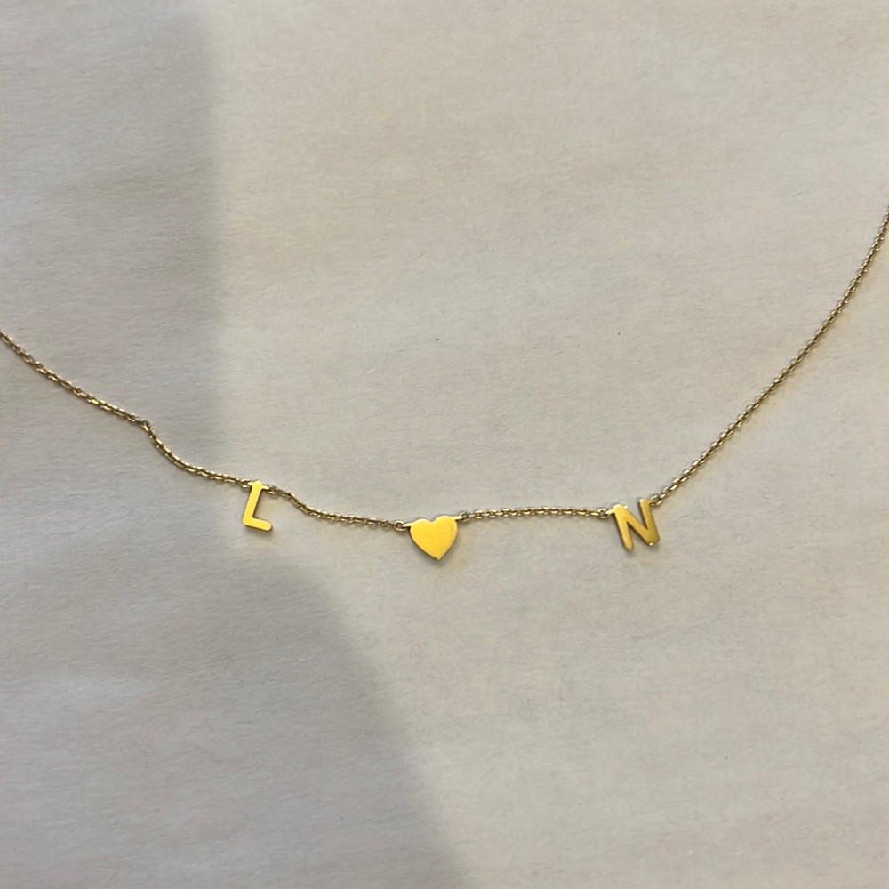 Custom letter necklace. Reads L 💗 N